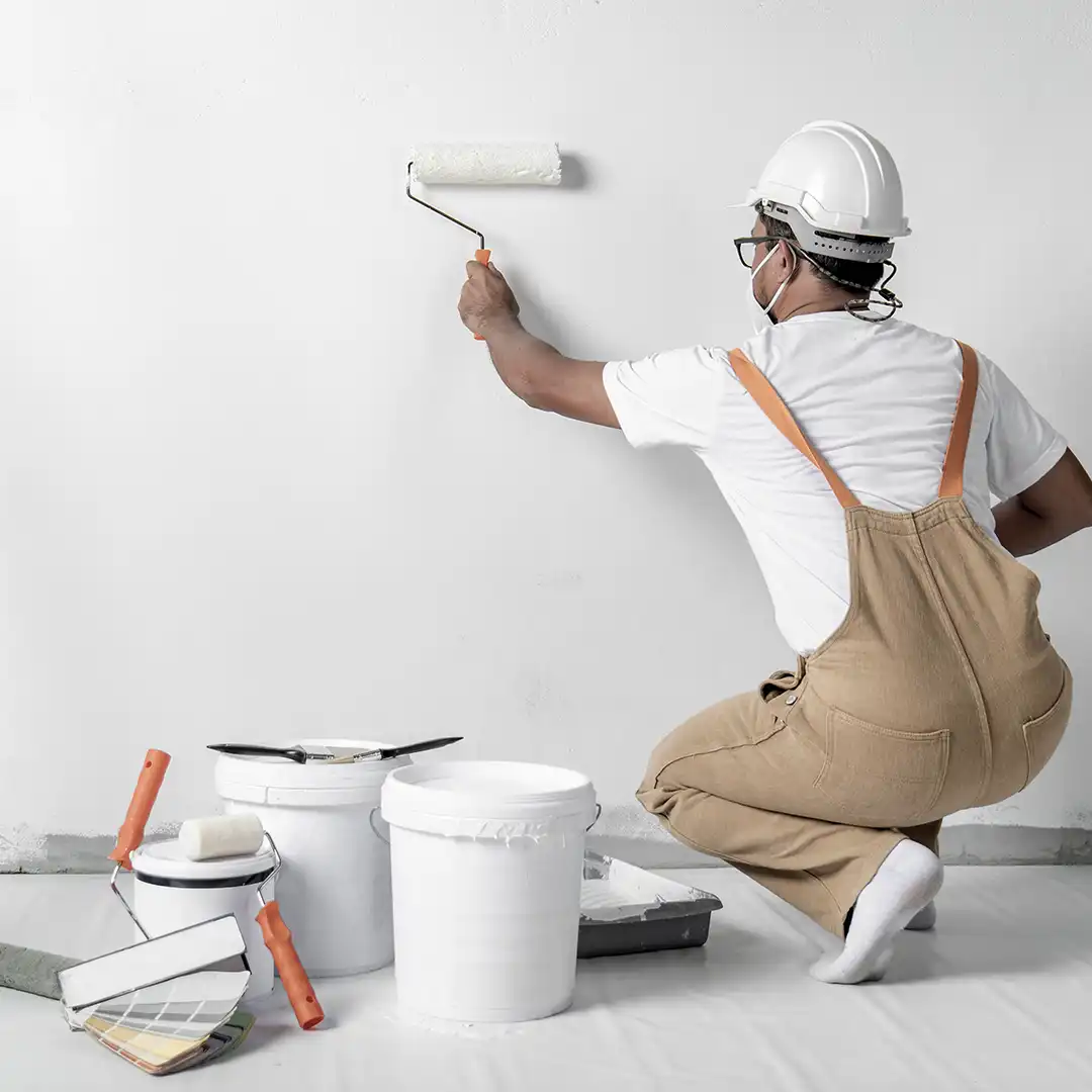 About 2 Man painting a wall white