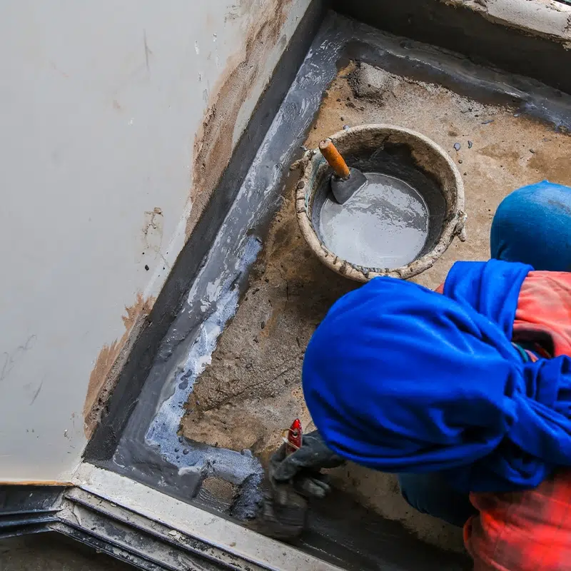 About 3 man waterproofing a floor